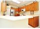 Spacious kitchen with ample counter space, wooden cabinets, and modern stainless steel appliances at 2591 Oneida Loop, Kissimmee, FL 34747