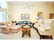 Bright living room featuring carpeted floors, a ceiling fan and neutral color tones at 2591 Oneida Loop, Kissimmee, FL 34747