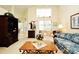 Bright living room with a large window, comfortable seating, and charming decor accents at 2591 Oneida Loop, Kissimmee, FL 34747