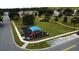 Aerial shot of the neighborhood park showcasing the playground, green space, and walking paths at 2591 Oneida Loop, Kissimmee, FL 34747