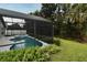 Enclosed pool area with a spa overlooking the lush green landscaping provides privacy and a tranquil retreat at 2591 Oneida Loop, Kissimmee, FL 34747