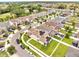 Community aerial view showcasing homes with solar panels, manicured lawns, and tree-lined streets at 2824 Noble Crow Dr, Kissimmee, FL 34744