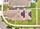 Aerial view of a modern home featuring a solar panel roof and lush green backyard at 2824 Noble Crow Dr, Kissimmee, FL 34744