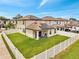 Exterior view of the home featuring a fenced yard and a patio area with a grill at 2824 Noble Crow Dr, Kissimmee, FL 34744
