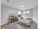 Bright bedroom with vinyl floors, modern furniture, and a view of the outdoors at 2824 Noble Crow Dr, Kissimmee, FL 34744
