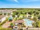 An aerial view showcasing a community pool, playground, and surrounding residential neighborhood at 2824 Noble Crow Dr, Kissimmee, FL 34744