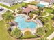Aerial view of a resort-style community pool with sun loungers and mature tropical landscaping at 2824 Noble Crow Dr, Kissimmee, FL 34744