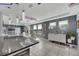 Bright living area features a dining area with chandelier, with a connecting kitchen, and tile flooring at 2824 Noble Crow Dr, Kissimmee, FL 34744