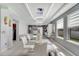 Bright dining area featuring a glass table, stylish white chairs, and modern ceiling lighting at 2824 Noble Crow Dr, Kissimmee, FL 34744