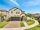 Charming two-story home with a brick driveway and lush landscaping at 2824 Noble Crow Dr, Kissimmee, FL 34744