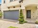 Inviting entryway with stone accents, neat shrubbery, and a modern front door at 2824 Noble Crow Dr, Kissimmee, FL 34744