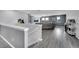 Upstairs living room with game console, wet bar, and comfortable gray leather sofa at 2824 Noble Crow Dr, Kissimmee, FL 34744