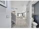 Bright hallway leading to an open living space, modern tile floors at 2824 Noble Crow Dr, Kissimmee, FL 34744