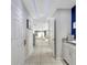 Open hallway with tiled floors leads to a staircase and dining area at 2824 Noble Crow Dr, Kissimmee, FL 34744