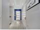 Bright hallway features modern lighting, white doors, and tiled flooring at 2824 Noble Crow Dr, Kissimmee, FL 34744