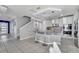 Modern kitchen with stainless steel appliances, a spacious island, and pendant lighting at 2824 Noble Crow Dr, Kissimmee, FL 34744