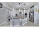 Bright kitchen featuring a large island, modern appliances, and unique pendant lighting, and stainless steel refrigerator at 2824 Noble Crow Dr, Kissimmee, FL 34744