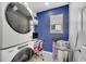 The laundry room features a washer and dryer, a blue wall, and a desk area at 2824 Noble Crow Dr, Kissimmee, FL 34744