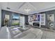 Living room with white leather sofa, fireplace, entertainment center, and sliding glass doors at 2824 Noble Crow Dr, Kissimmee, FL 34744