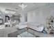 Open living space with a modern white kitchen, dining area, and white leather sectional at 2824 Noble Crow Dr, Kissimmee, FL 34744