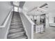 Open floor plan featuring a staircase leading to the modern kitchen and living room at 2824 Noble Crow Dr, Kissimmee, FL 34744