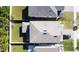 Birds eye view of a grey roof and manicured backyard with hardscape features at 2833 Noble Crow Dr, Kissimmee, FL 34744
