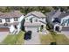 Aerial view of a home with a well-manicured lawn and a paved driveway at 2833 Noble Crow Dr, Kissimmee, FL 34744