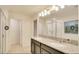 Bright bathroom boasts double sinks, granite counters, shower and tub at 2833 Noble Crow Dr, Kissimmee, FL 34744