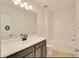 Bright bathroom featuring a tub and shower combo and a vanity with modern fixtures at 2833 Noble Crow Dr, Kissimmee, FL 34744