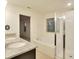 Well-lit bathroom boasts double sinks, granite counters, tub, glass enclosed shower at 2833 Noble Crow Dr, Kissimmee, FL 34744