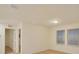 Neutral bedroom featuring a window with blinds, carpet flooring and an entry door at 2833 Noble Crow Dr, Kissimmee, FL 34744