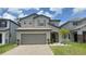 Charming two-story home with a two-car garage and a well-manicured lawn at 2833 Noble Crow Dr, Kissimmee, FL 34744