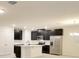 Modern kitchen with stainless steel appliances, a large island, and dark cabinetry at 2833 Noble Crow Dr, Kissimmee, FL 34744