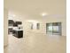 Open-concept living room with tile floors, natural light, and access to the outdoors at 2833 Noble Crow Dr, Kissimmee, FL 34744
