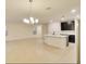 Open-concept living room with tile floors, natural light, and a view of the kitchen at 2833 Noble Crow Dr, Kissimmee, FL 34744