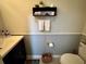 Cozy bathroom with a dark vanity, modern shelving, and neatly arranged fresh white towels at 2862 Grasmere View Pkwy, Kissimmee, FL 34746