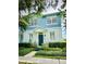 Charming two-story home boasts a landscaped yard, blue accents, and a welcoming front door with wreath at 2862 Grasmere View Pkwy, Kissimmee, FL 34746