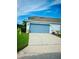 A two car garage with an automatic door, storage, and a gray SUV parked inside at 2862 Grasmere View Pkwy, Kissimmee, FL 34746