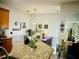 Bright eat-in kitchen with granite countertops, stainless steel appliances, and dining area with pendant lighting at 2862 Grasmere View Pkwy, Kissimmee, FL 34746