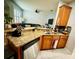 Updated kitchen with granite counters, stainless steel dishwasher, and a view into the living area at 2862 Grasmere View Pkwy, Kissimmee, FL 34746