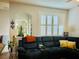 Comfortable living room with a sectional sofa, decorative pillows, and bright natural light from large window at 2862 Grasmere View Pkwy, Kissimmee, FL 34746
