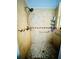 Walk-in shower featuring neutral tile, grab bars, and convenient shelving for toiletries and accessories at 2862 Grasmere View Pkwy, Kissimmee, FL 34746