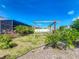 The backyard has tropical landscaping and an outdoor pergola at 301 Terranova Blvd, Winter Haven, FL 33884