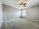 Comfortable bedroom featuring neutral carpet, a ceiling fan, and a bright window at 301 Terranova Blvd, Winter Haven, FL 33884