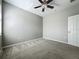 Bright bedroom with carpet, ceiling fan, and light gray colored walls at 301 Terranova Blvd, Winter Haven, FL 33884