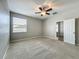 Spacious bedroom featuring plush carpet, ceiling fan, and neutral paint at 301 Terranova Blvd, Winter Haven, FL 33884