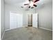 Spacious bedroom with neutral carpet, ceiling fan, and plenty of closet space at 301 Terranova Blvd, Winter Haven, FL 33884