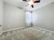 Cozy bedroom featuring neutral carpet, a ceiling fan, and a bright window at 301 Terranova Blvd, Winter Haven, FL 33884