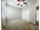 Bright bedroom featuring neutral carpet, a ceiling fan, and a double door closet at 301 Terranova Blvd, Winter Haven, FL 33884