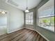 Bright dining area featuring wood floors, modern lighting, and large windows offering backyard views at 301 Terranova Blvd, Winter Haven, FL 33884